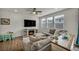Cozy living room with a fireplace and a comfortable gray sectional sofa at 9983 Cluny Ave, Las Vegas, NV 89178