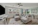 Comfortable living area with large windows and a gray sectional sofa at 9983 Cluny Ave, Las Vegas, NV 89178