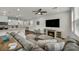 Open-concept living room with modern furnishings and an electric fireplace at 9983 Cluny Ave, Las Vegas, NV 89178