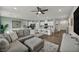 Open concept living space featuring a large sofa, dining area, kitchen with modern cabinets at 9983 Cluny Ave, Las Vegas, NV 89178