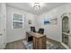 Well-lit home office with wood desk, modern decor, and ample natural light at 9983 Cluny Ave, Las Vegas, NV 89178