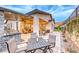 Elegant outdoor patio with a built-in grill, dining area, and comfortable seating with mountain views at 101 Mirage View Dr, Henderson, NV 89011