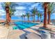 Stunning community pool surrounded by lush palm trees and comfortable lounge chairs at 101 Mirage View Dr, Henderson, NV 89011