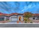 Inviting single-story home with a well-manicured yard and mountain views provides great curb appeal at 101 Mirage View Dr, Henderson, NV 89011