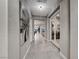 Hallway with decorative lighting, tile flooring, and views of the home's open-concept living spaces at 101 Mirage View Dr, Henderson, NV 89011