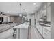 Open-concept living area with kitchen island, dining space, and a spacious living room at 101 Mirage View Dr, Henderson, NV 89011