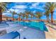 Stunning community pool surrounded by palm trees, lounge chairs, and clear blue skies at 101 Mirage View Dr, Henderson, NV 89011