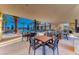 Relaxing poolside seating area with shaded tables and chairs, perfect for enjoying the pool at 101 Mirage View Dr, Henderson, NV 89011