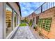 Inviting side yard with artificial turf, a modern water feature, and stylish landscaping at 101 Mirage View Dr, Henderson, NV 89011