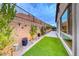 Lush side yard with artificial turf and landscaped borders, perfect for a low-maintenance garden at 101 Mirage View Dr, Henderson, NV 89011