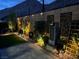 Picturesque side yard with a modern water feature and ambient lighting for evening enjoyment at 101 Mirage View Dr, Henderson, NV 89011