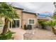Private backyard with stone patio, desert landscaping, and tan exterior at 10311 Birch Bluff Ln, Las Vegas, NV 89145