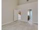 Neutral bedroom with vaulted ceilings, tile flooring, and ensuite bathroom entrance at 10311 Birch Bluff Ln, Las Vegas, NV 89145