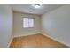 Bright bedroom features wood-look floors and a window with blinds for natural light at 10311 Birch Bluff Ln, Las Vegas, NV 89145