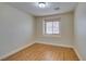 This is a bright bedroom featuring wood-look floors and a window with blinds at 10311 Birch Bluff Ln, Las Vegas, NV 89145