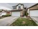 Charming two-story home featuring a two-car garage, well-kept lawn and appealing architectural details at 10311 Birch Bluff Ln, Las Vegas, NV 89145