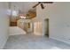 Bright living room with stairs to the second floor, neutral color palette, and tile flooring at 10311 Birch Bluff Ln, Las Vegas, NV 89145