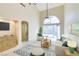Bright living room with high ceilings, tiled floor, and large sliding glass door to backyard at 10311 Birch Bluff Ln, Las Vegas, NV 89145