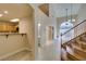 Entryway with view to the staircase, living room, kitchen, and powder room at 10311 Birch Bluff Ln, Las Vegas, NV 89145