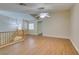 Open loft area with wood floors, featuring a ceiling fan and natural light at 10311 Birch Bluff Ln, Las Vegas, NV 89145