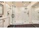 Luxurious bathroom with double shower featuring seamless glass doors and modern fixtures at 10476 Tyler Park Ave, Las Vegas, NV 89135