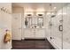 Modern bathroom features dual sinks, a marble-tiled shower with glass enclosure, and sleek fixtures at 10476 Tyler Park Ave, Las Vegas, NV 89135