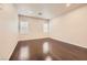 Empty bedroom showcasing gleaming hardwood floors and bright natural light from shuttered windows at 10476 Tyler Park Ave, Las Vegas, NV 89135