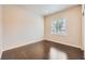 Bright bedroom featuring hardwood floors and a window with shuttered blinds at 10476 Tyler Park Ave, Las Vegas, NV 89135