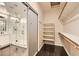 Walk-in closet featuring custom shelving and ample storage adjacent to a modern glass shower at 10476 Tyler Park Ave, Las Vegas, NV 89135