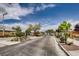 Gated entrance to the community with lush landscaping, offering privacy and security at 10476 Tyler Park Ave, Las Vegas, NV 89135