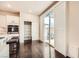 Kitchen with stainless steel appliances, white cabinets, island, sliding glass doors to the outside, and an open pantry at 10476 Tyler Park Ave, Las Vegas, NV 89135