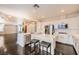 Open-concept kitchen with white cabinets, stainless steel appliances, a marble island, and seamless flow into the living area at 10476 Tyler Park Ave, Las Vegas, NV 89135