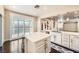 Well-lit kitchen boasts white cabinets, stainless steel appliances, marble countertops, and sliding glass doors to the outside at 10476 Tyler Park Ave, Las Vegas, NV 89135
