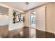 Inviting living room with dark wood floors, neutral color scheme, sliding glass doors to outside, and cactus decor at 10476 Tyler Park Ave, Las Vegas, NV 89135