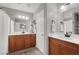 Bright bathroom with dual vanities, decorative mirrors, and ample cabinet space at 10608 Kennedy Peak Ln, Las Vegas, NV 89166