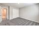 This is a bedroom with gray carpet and white sliding door closet at 10778 Hickam Ave, Las Vegas, NV 89129