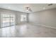 Spacious living room featuring neutral walls, tile floors, and sliding glass doors at 10778 Hickam Ave, Las Vegas, NV 89129