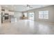 Open-concept living space with a kitchen island, dining area, and tiled floors at 10778 Hickam Ave, Las Vegas, NV 89129