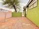 Sideyard featuring rock landscaping, peach and avocado block walls, and minimal plantings at 1080 Laguna Park Ct, Las Vegas, NV 89110