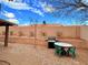Backyard featuring desert landscaping, BBQ, patio set, and block wall for privacy at 1080 Laguna Park Ct, Las Vegas, NV 89110