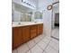Bathroom featuring double sinks with wooden cabinets, providing ample space and storage at 1080 Laguna Park Ct, Las Vegas, NV 89110