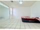 Large bedroom with tile floors, ceiling fan and mirrored wall at 1080 Laguna Park Ct, Las Vegas, NV 89110