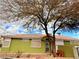 Exterior view showcasing the well-maintained yard with a mature tree, enhancing its curb appeal at 1080 Laguna Park Ct, Las Vegas, NV 89110