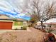 Exterior of the home with drought tolerant landscaping, large trees, and inviting curb appeal at 1080 Laguna Park Ct, Las Vegas, NV 89110