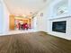 Open floorplan with fireplace and adjacent kitchen/dining area at 1080 Laguna Park Ct, Las Vegas, NV 89110