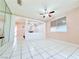 Bright living area with tile flooring, ceiling fan, fireplace, and partial wall design at 1080 Laguna Park Ct, Las Vegas, NV 89110