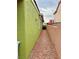 Side yard featuring minimal clearance, rock landscaping, and avocado and peach block walls at 1080 Laguna Park Ct, Las Vegas, NV 89110