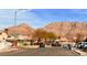 Neighborhood street view featuring single-Gathering homes and the McCullough Mountain Range in the background at 1080 Laguna Park Ct, Las Vegas, NV 89110