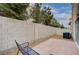 This backyard features a patio, gravel, a bench, privacy wall, and view of the neighborhood trees at 11092 Abbeyfield Rose Dr, Henderson, NV 89052