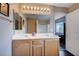 This bathroom features a double sink vanity with a large mirror and plenty of lighting at 11092 Abbeyfield Rose Dr, Henderson, NV 89052